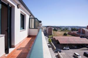 - un balcon avec vue sur le parking dans l'établissement Laros Pios Alojamiento, à Villalba