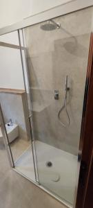 a shower with a glass door in a bathroom at Casa di Gino in Pontedera