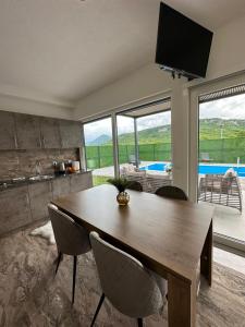 a kitchen and dining room with a wooden table and chairs at Terra Solis Bihać Villa 2 in Bihać