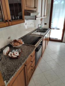 a kitchen with a counter with a sink and a stove at Casa di Gino in Pontedera
