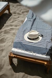 un chapeau assis sur une serviette sur une table dans l'établissement Hôtel La Plage 5 étoiles La Grande Motte, à La Grande Motte