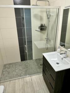 a bathroom with a shower and a sink at Princess Retreat Beautiful Modern Aprt 2 min walk from Quarteira Beach in Quarteira