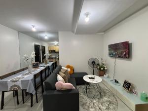 a living room with a couch and a table at Casa Moanna 2BR Condo with Dining, kitchen, Living Area and Netflix in Mandaue City
