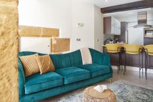 sala de estar con sofá verde y cocina en pilliku apartamentua garaje incluido, en Orio