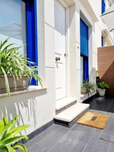 a front door of a house with plants at Adosadito playa Oliva in Oliva