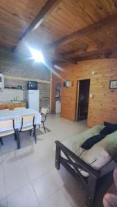 a large room with two beds and a kitchen at Los Tronquitos in Santa Rosa de Calamuchita