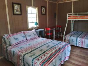 a bedroom with two beds and a bunk bed at Camping Cabin with private Bathroom in Maumee