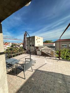 a patio with a table and an umbrella at Ronia apartment in Kaštela