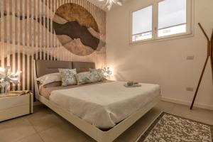 a bedroom with a bed and two windows at Luxury Sofia Home Alghero in Alghero