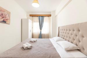 a bedroom with a large bed with towels on it at The Retreat in Kos Central in Ampavris