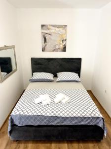 a bedroom with a bed with two towels on it at Ronia apartment in Kaštela