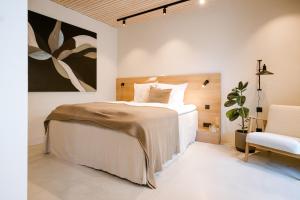 a bedroom with a large bed and a chair at Studio Nummer Zwei in Windischeschenbach