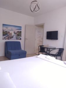 a living room with a blue couch and a table at stockholm in Bregvija
