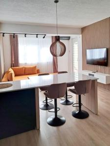 - une cuisine avec une table, des chaises et un canapé dans l'établissement Luxurious 1BR Apartment with Elevator Near Lake Ohrid, à Ohrid