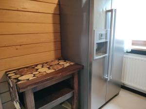 a kitchen with a refrigerator and a table with food at Domki Klimkówka in Klimkówka