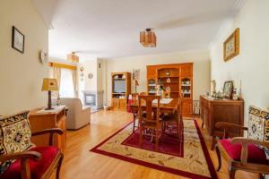 a living room with a table and a dining room at Remédios Apartment in Lamego