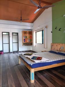 a bedroom with a bed in a room at Sai Homestay in Malvan