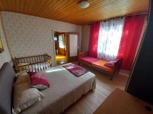 a bedroom with a bed and a couch and a window at Etno House Mira in Virpazar