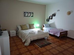Posteľ alebo postele v izbe v ubytovaní A casa di zia Maria