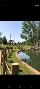 uma cerca ao lado de um lago num parque em Chambre familiale em Aït Mouloud