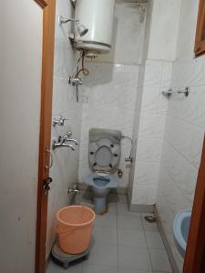 a small bathroom with a toilet and a sink at Aman guest house in Katra