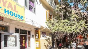 a building with a sign for a mental house at Aman guest house in Katra