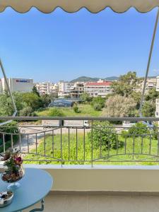 a balcony with a table and a view of a city at FK Maison in Agrinio