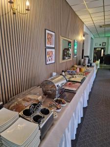 a long buffet line with food on it at Hotel Leliwa in Leśna
