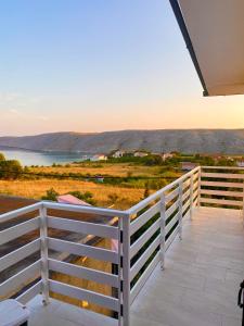a balcony with a fence and a view of the water at Sea View Apartments Nini in Vlašići