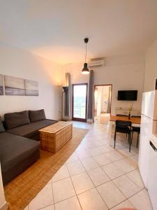 a living room with a couch and a table at Sea View Apartments Nini in Vlašići