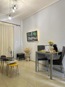 a living room with a dining room table and chairs at FK Maison in Agrinio