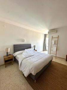 a bedroom with a large bed and a window at Hostal SolFina in Palafolls