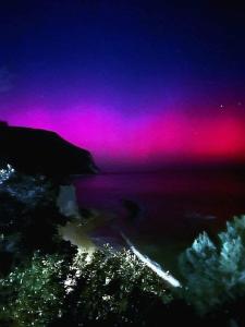 a purple and pink sky over the water at night at CASA ELEGANTE in Martinsicuro