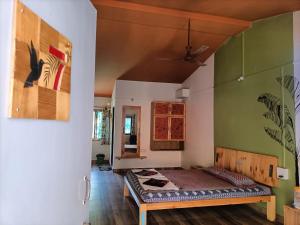 a room with a bed in the middle of a room at Sai Homestay in Malvan
