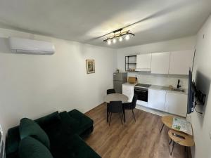 a living room with a couch and a table at Ronia apartment in Kaštela