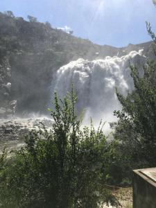 a view of a waterfall with a tree at Casa en Río Grande in La Bajada
