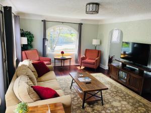 a living room with a couch and a tv at State Street Cottage, Suite 2 in Pullman