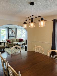a dining room with a table and a couch at State Street Cottage, Suite 2 in Pullman