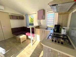 a kitchen with a stove and a stove top oven at Camping Dolce Vita in Calvi