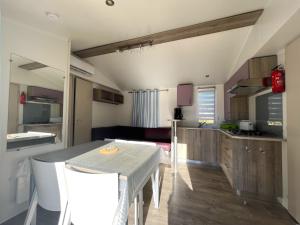 a kitchen and dining room with a table and chairs at Camping Dolce Vita in Calvi