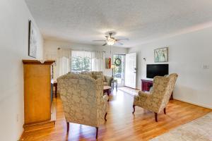a living room with a table and chairs and a television at Chatham Getaway with Fireplace, Deck and Gas Grill! in Chatham