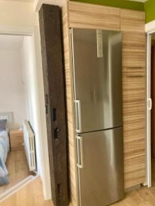 a kitchen with a stainless steel refrigerator in a room at Apartamento San Gregorio in Pamplona