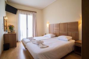 Letto o letti in una camera di THOLOS HOTEL