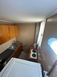a small kitchen with a sink and a counter at Nikos Holidays Apartment 1 in Petra