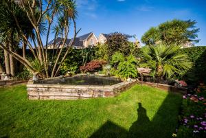 a garden with a pond in the middle of a yard at Hambledon Hotel in Shanklin