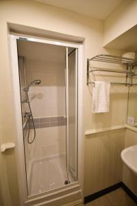 a bathroom with a shower with a glass door at Red Lion Inn in Hawkshead
