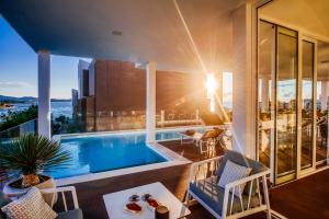 a house with a swimming pool and a balcony at Dedaj Resort - Villa Delux with Sea View Pool in Zadar