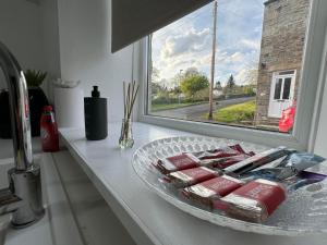 a plate of food on a counter next to a window at Durham Dales Luxury Cottage in Stanhope