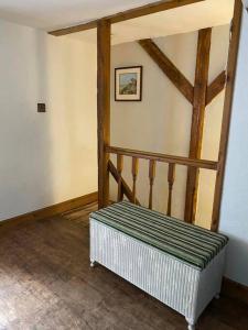 a room with a stairway with a bench in it at Mill Cottage, Upper Hulme in Upper Hulme