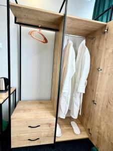 a closet with white clothes hanging in it at Garden Hotel in Akhalk'alak'i